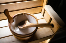 Wooden Sauna Bucket With Spoon On Bench. Traditional Finnish Sauna Interior Detail