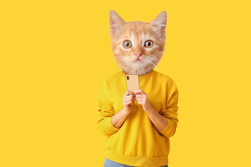 Wall Mural - Cute cat with human body holding smartphone on yellow background