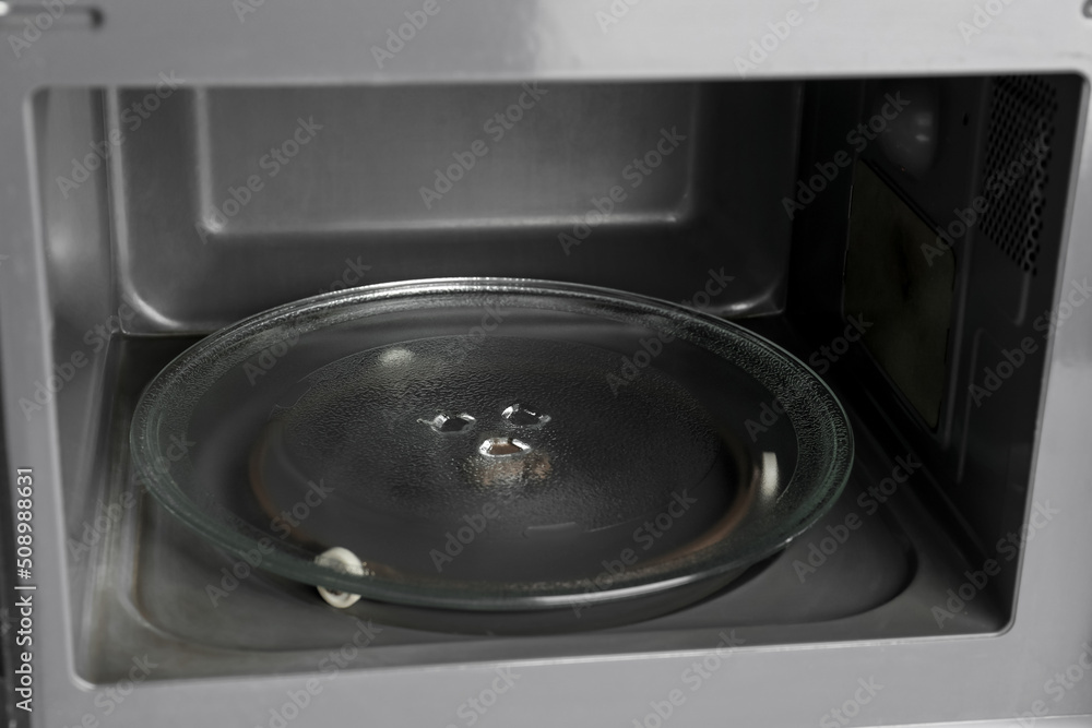 Modern open microwave oven, closeup
