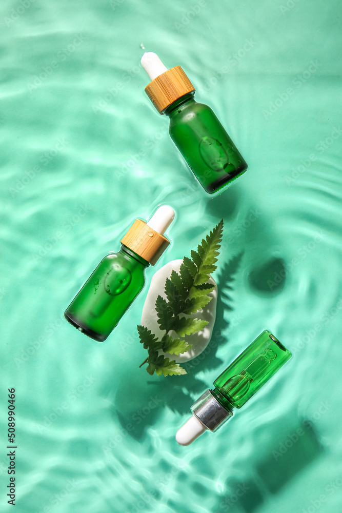 Bottles with natural serum in water on color background