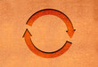 Rotate orange Symbol on cardboard background 