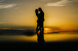 silhouette of a loving couple embracing at sunset