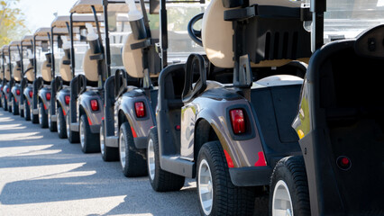 Wall Mural - A row of electric golf carts on a golf course.