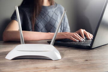woman working in computer with wifi router