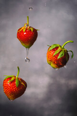 Poster - Strawberries with water droplets with blurred background.