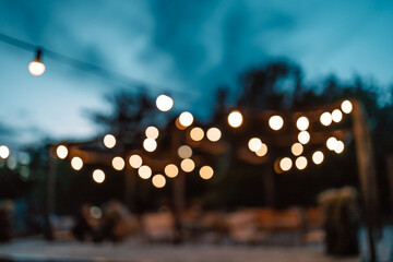 Blurred image of the terrace interior with garland lights. Abstract image. 