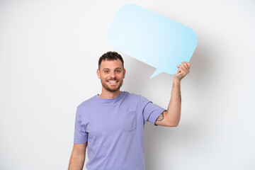 Wall Mural - Young Brazilian man isolated on white background holding an empty speech bubble