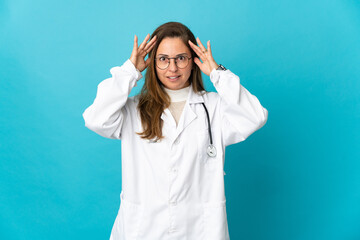 Wall Mural - Middle age Brazilian doctor woman isolated on blue background with surprise expression