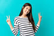© luismolinero - Teenager Brazilian girl over isolated blue background showing victory sign with both hands