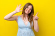 Young caucasian woman isolated on yellow background counting seven with fingers