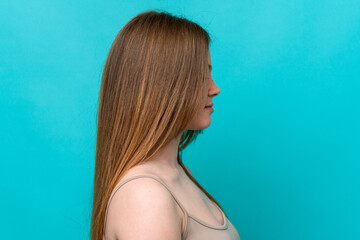 Young caucasian woman isolated on blue background . Portrait