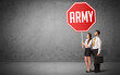 © ra2 studio - Young business person holding road sign