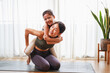 © chayantorn - Asian young mother teaching her daughter to yoga pose and exercise together on yoga mat