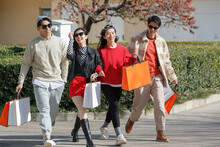 Happy Fashionable Young People Go Shopping With Holding Shopping Bags