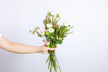 The Young Woman's Hand Holding A Bouquet