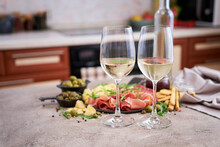 Two Glasses Of White Wine With Italian Antipasto Meat Platter On Background