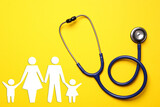 Fototapeta Kawa jest smaczna - Health insurance. Stethoscope and illustration of family on yellow background, top view