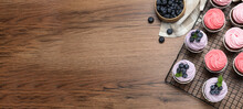 Sweet Cupcakes With Fresh Blueberries On Wooden Table, Flat Lay With Space For Text. Banner Design