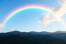 Picturesque Mountain Landscape And Beautiful Rainbow In Blue Sky