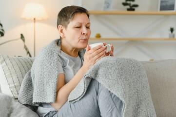 Wall Mural - great looking middle aged woman having a calm morning and enjoying her coffee.