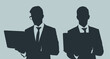 © DesignStory - Dark gray silhouettes portrait of two businessmen are posing and holding laptop on light gray background, flat line vector and illustration.