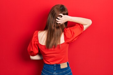 Poster - Redhead young woman wearing casual red t shirt backwards thinking about doubt with hand on head