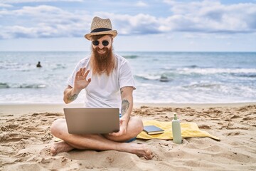 Sticker - Young redhead man having video call using laptop at the beach.