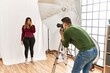 © Krakenimages.com - Young woman at photography studio looking stressed and nervous with hands on mouth biting nails. anxiety problem.