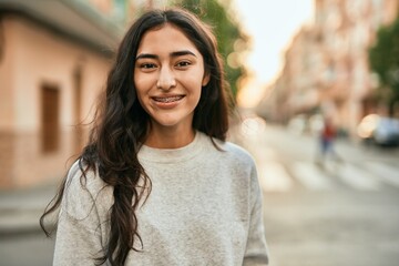 Wall Mural - Young middle east girl smiling happy standing at the city.