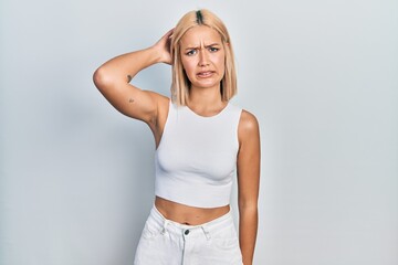 Sticker - Beautiful blonde woman wearing casual style with sleeveless shirt confuse and wonder about question. uncertain with doubt, thinking with hand on head. pensive concept.