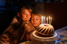 Preteen Kid Boy Celebrating Tenth Birthday. Little Toddler Girl, Sister Child And Two Kids Boys Brothers Blowing Together Candles On Cake. Happy Healthy Family Portrait With Three Children Siblings