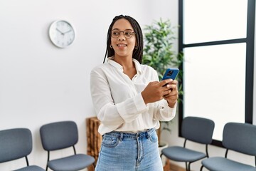 Poster - Young african american woman smiling confident using smartphone at waiting room