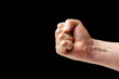 © EduardSkorov - Fist of a man close-up on a black background