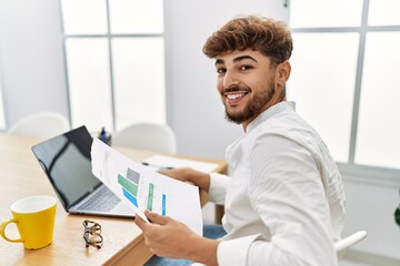 Wall Mural - Young arab man using laptop working at office