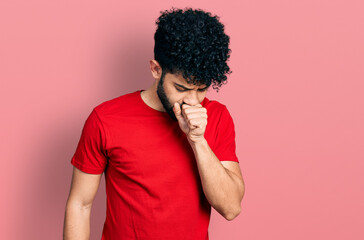 Canvas Print - Young arab man with beard wearing casual red t shirt feeling unwell and coughing as symptom for cold or bronchitis. health care concept.