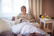 © Halfpoint - Happy overweight woman reading book in bed at home. Morning routine, healthy breakfats.