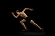 © master1305 - Studio shot of young muscular woman running isolated on black background. Sport, track-and-field athletics, competition and active lifestyle concept