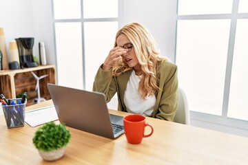 Sticker - Beautiful blonde woman working at the office with laptop tired rubbing nose and eyes feeling fatigue and headache. stress and frustration concept.