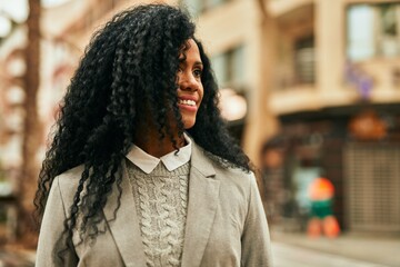 Sticker - Middle age african american businesswoman smiling happy standing at the city.