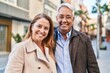 © Krakenimages.com - Middle age man and woman couple hugging each other standing at street