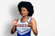 Young African American Woman Wearing Cheerleader Uniform Disgusted Expression, Displeased And Fearful Doing Disgust Face Because Aversion Reaction. With Hands Raised