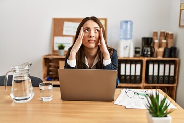 Young hispanic woman business worker overworked working at office