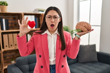 Canvas Print - Young latin woman working as couple therapist angry and mad screaming frustrated and furious, shouting with anger. rage and aggressive concept.