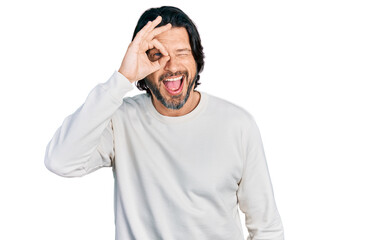 Poster - Middle age caucasian man wearing casual clothes doing ok gesture with hand smiling, eye looking through fingers with happy face.