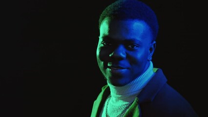 Wall Mural - Successful man. Good mood. Neon light people. Portrait of happy optimistic guy smiling in joy emotion in vibrant colorful glow isolated on dark background.