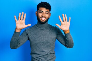 Poster - Arab man with beard wearing turtleneck sweater showing and pointing up with fingers number ten while smiling confident and happy.