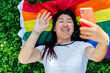 Woman taking a selfie with the rainbow flag