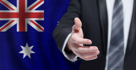 Welcome to the Australia. Nand on Australian flag background. Business, politics, cooperation and travel concept