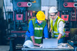 © kittikunfoto - The worker teammate engineer white and yellow safety helmet working together and discussing and white helmet order to teammate as follow instruction on tablet