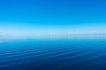 clear water texture in blue and orange. background of the ocean and the sea backlit by the sun. natu